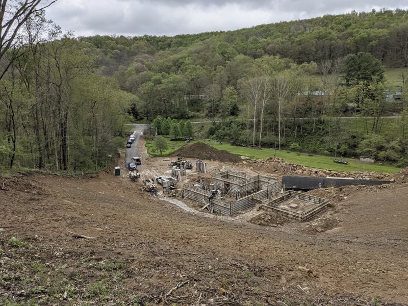 Excavation and foundation forms on wooded hillside in Butler County