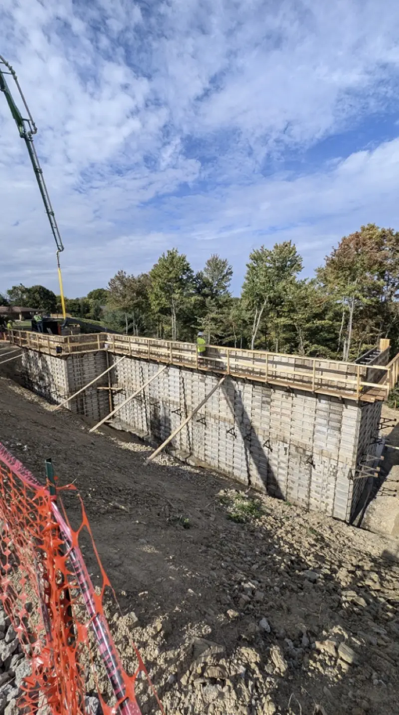 Foundation wall forms with concrete pump truck on site